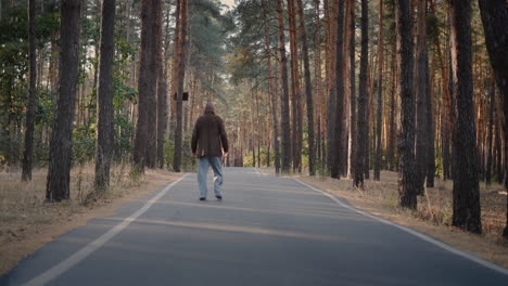 Drunk-homeless-man-walks-on-the-road-in-the-park