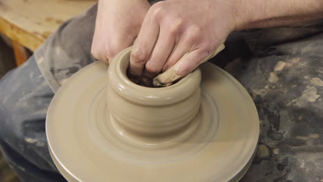 The-hands-of-a-potter-make-a-jug-on-a-potter's-wheel-1