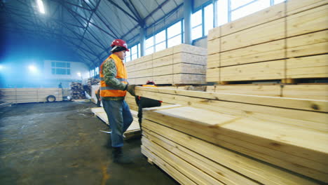 A-group-of-workers-moves-wood-slats-in-stock-1