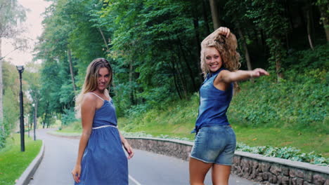Carefree-young-women-walk-down-the-road-in-the-park