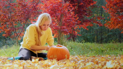 Young-Woman-Carves-A-Pumpkin