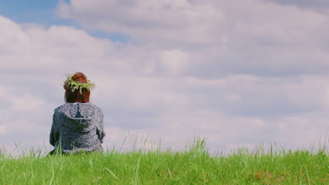 A-Lonely-Woman-Is-Sitting-On-A-Green-Hill