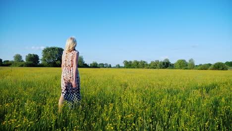 A-Woman-Is-Walking-Along-A-Beautiful-Meadow-With-Flowers-At-Sunset-Only-The-Legs-Are-Visible-In-The-Frame-1