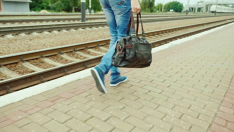 A-Man-With-A-Travel-Bag-Goes-Along-The-Railroad
