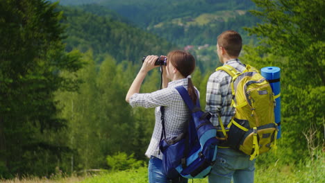 Young-Tourists-In-The-Forest-Looking-Through-Binoculars-1