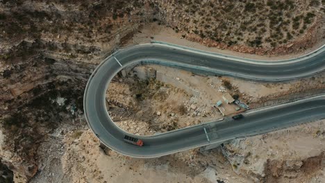 Aerial-Birds-Eye-View-Of-Lorry-On-Curved-CPEC-Road-At-Fort-Munro-In-Pakistan