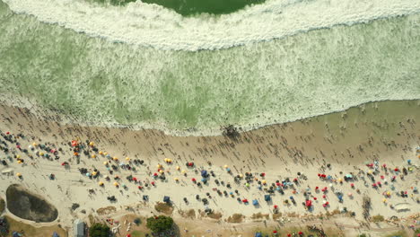 Aerial-View-Of-Tourists-At-Camps-Bay-Beach-With-Beach-Umbrellas-At-Summer-In-Cape-Town,-South-Africa