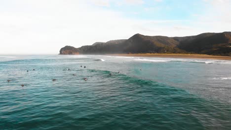 A-surfer-surfs-on-a-wave-on-the-Piha-Beach-in-New-Zealand
