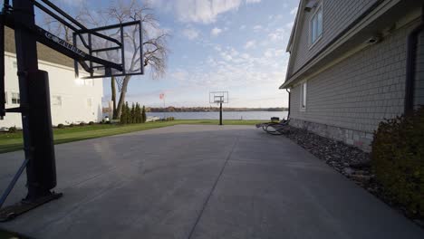 full-length-basketball-court-in-the-backyard-of-a-luxury-home-on-the-lake