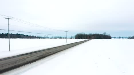 Camera-speeding-along-a-country-road-in-winter