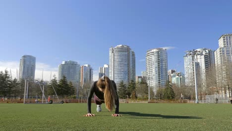Young-woman-doing-burpees-exercise-in-park-slow-motion-shot