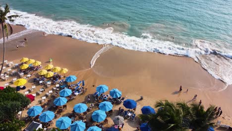Unrecognizable-people-enjoying-beach-in-sunny-day,-Sri-Lanka