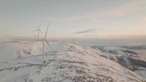 Aerial-of-Wind-turbine-on-snow-mountain
