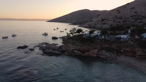 Beautiful-flying-overview-of-Stara-Baska-Beach-Camp-and-trailer-park-on-Krk-Island-at-sunset-in-Croatia