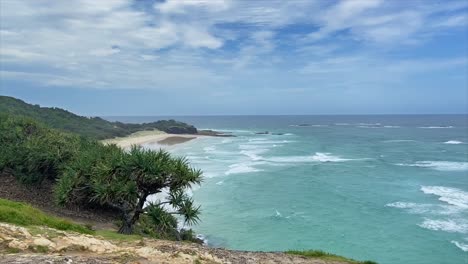 Stunning-view-along-a-tropical-Australian-coastline-to-a-headland,-over-classical-golden-sand-beaches-and-the-ubiquitous-Pandanus-trees