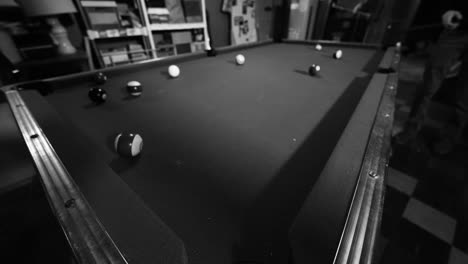 Shadows-dancing-across-a-felt-pool-table-in-black-and-white