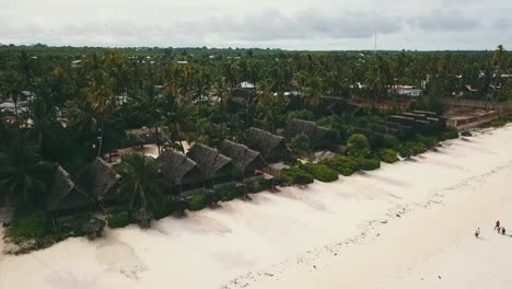 Fantastic-aerial-flight-fly-from-up-to-down-crane-drone-shot-in-front-of-a-nice-luxury-resort