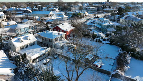 Aerial-establishing-shot-of-American-town-in-winter-snow-on-sunny-day