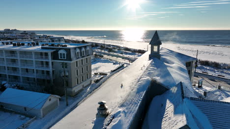 Oceanfront-hotel-in-winter-snow-on-sunny-day