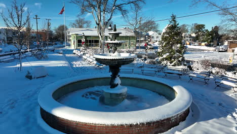 Empty-water-fountain-in-town-park-during-winter-snow