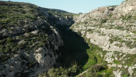 AERIAL:-Flying-Over-Canyon-Near-Magrr-Ix-Xini-Bay-on-Gozo-Island-in-Malta