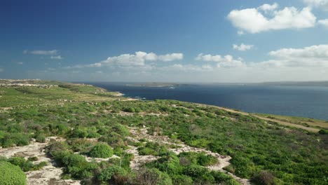 AERIAL:-Revealing-Comino-Island-and-Greenery-Plains-of-Gozo-Island-near-Blue-Mediterranean-Sea