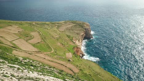 AERIAL:-Rocky-Steep-Ta-Cenc-Cliffs-on-Windy-Day-near-Blue-Mediterranean-Sea-Coastline