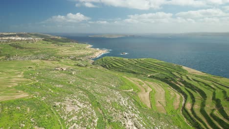 AERIAL:-Greenery-Plains-of-Ta-Cenc-Cliffs-near-Blue-Mediterranean-Sea-in-Gozo-Island