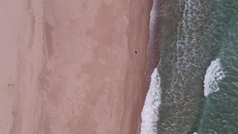 Drone-Pedestal-Shot-Single-Male-Fisherman-on-Rough-Wavey-Cape-Cod-Summer-Beach