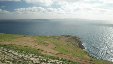AERIAL:-Steep-Ta-Cenc-Cliffs-Being-Washed-by-Blue-Mediterranean-Sea