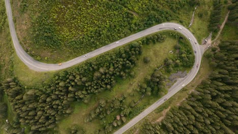 4k-real-time-aerial-view,-of-a-winding-road-in-the-mountains-of-Low-Tatras-National-Park-in-Slovakia