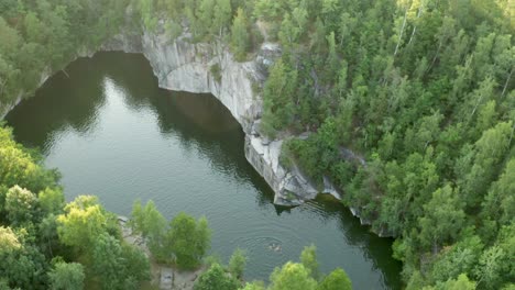 Aerial-drone-pan-down-shot-of-a-lake-in-an-old-quarry-called-Rampa-in-Czech-republic