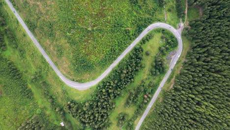 Aerial-view-of-a-rural-mountain-landscape-with-a-curvy-road-in-the-mountains-of-Low-Tatras-National-Park-in-Slovakia