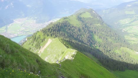 Two-hikers-following-a-trail-on-mountain-ridge-in-Emmental-Alps