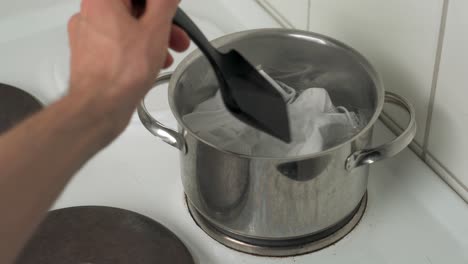 Sanitizing-used-face-masks-in-boiling-water