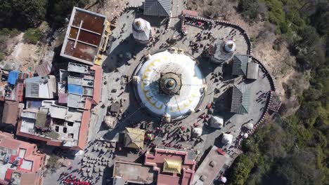 A-rising-straight-down-aerial-view-time-lapse-of-Swayambhunath-Stupa-in-the-city-of-Kathmandu,-Nepal