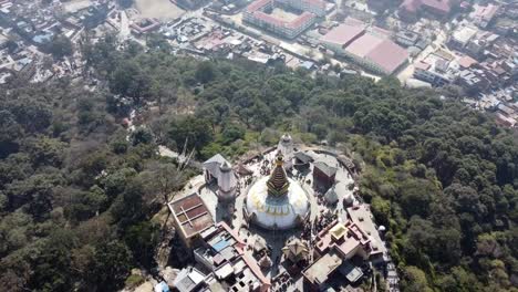 A-rising-spiral-view-of-the-Swayambhunath-Stupa-on-the-top-of-a-hill-in-the-city-of-Kathmandu,-Nepal