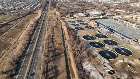 A-high-angle-aerial-view-of-a-waste-water-treatment-plant-on-a-sunny-day