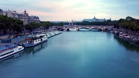 aerial-moving-forward-going-down,-towards-blue-seine-River-and-Grand-Palais-at-snrise