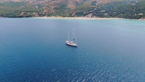 Aerial-drone-view-of-beautiful-boat-in-apraos-beach-in-summer-corfu-greece