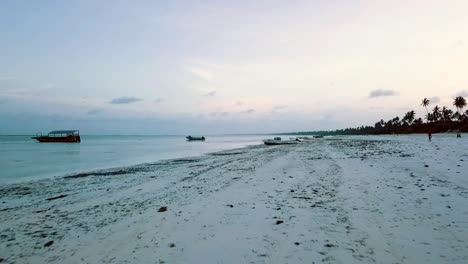 Fantastic-long-aerial-drone-flight-over-the-coast-line-of-a-empty-lost-castaway-paradise-white-sand-dream-beach-at-sun-set-dusk-on-Zanzibar,-Africa-2019