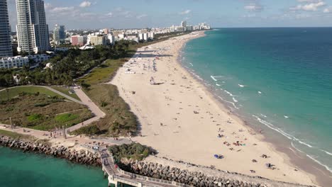 Aerial-view-overlooking-people-sun-bathing-on-the-South-Point-beach,-in-Miami,-USA