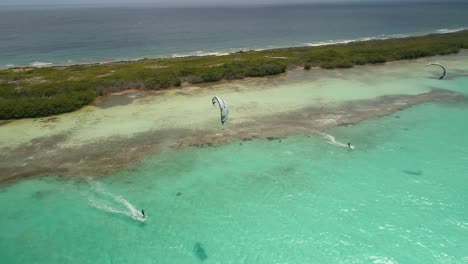 Aerial-approach-Kitesurfer-USING-WHITE-KITE-ON-FLAT-WATER-NEAR-TROPICAL-MANGROVE-IN-SALINAS-LOS-ROQUES