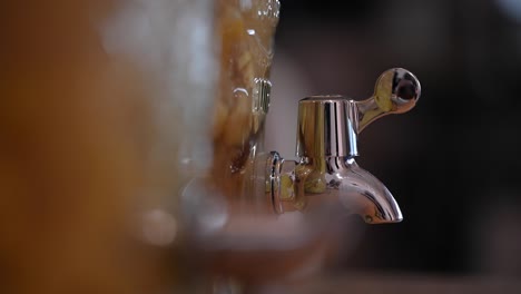A-stationary-shot-of-a-juice-pitcher's-faucet