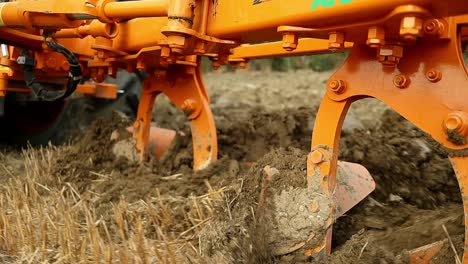 close-up-of-Mechanical-furrow-plough-tool-dragging-at-lands-of-rural-Italy