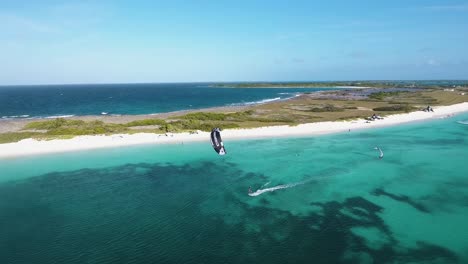 Drone-shot-KITESURFER-sail-RIGHT-TO-LEFT-caribbean-white-sand-BEACH-ISLAND,-Los-Roques