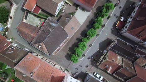 An-onward-moving-top-view-aerial-footage-of-the-village-from-the-clock-tower-while-revealing-the-houses,-the-roads,-and-the-traffic