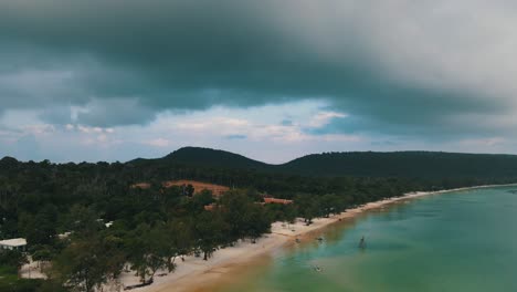 Huge-looming-clouds-over-the-green-nature-of-the-tourist-island-of-Koh-Rong-Sanloem-while-the-clear-sea-reflects-the-clouds-beautifully