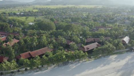 Total-view-tracking-shot-coastline-Langkawi,-beach,-coast,-trees-and-buildings,-no-people,-daylight