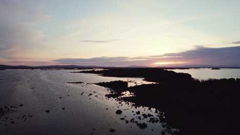 Beautiful-aerial-flying-over-gigantic-irish-lough-corrib-with-many-small-island-silhouettes-in-the-water